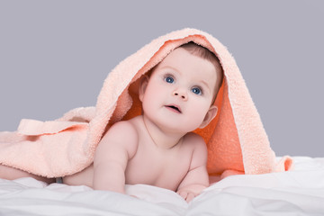 Baby girl or boy after shower with towel on head, isolated