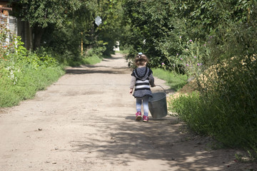 Child walking along the road