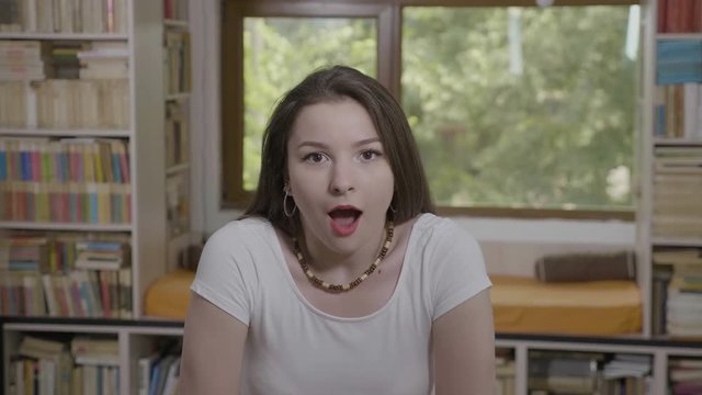 Pretty millennial woman expressing surprise holding her head in disbelief and shock 