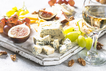 Fototapeta na wymiar Cheese plate with grapes, figs and nuts.