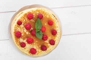 Pancakes on white wooden table, top view
