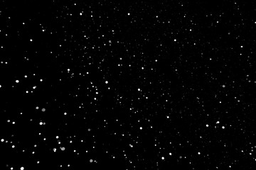Snowflakes in the night sky on a black background