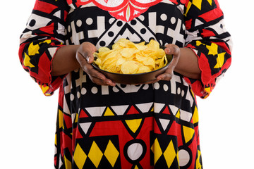 Studio shot of fat black African woman holding bowl of potato ch