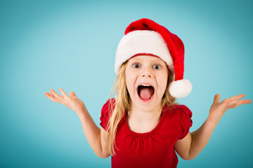 Festive Little Christmas Girl in Santa Hat, Isolated on Teal