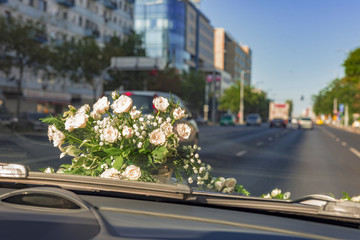 wedding car with flowers going on road