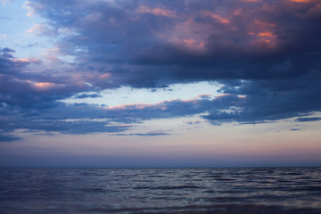 Naklejka na ściany i meble View of beautiful clouds in the evening at sunset from the sea s