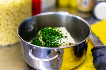 Cutted Dill on Top of The Butter in the Steel Pot