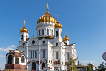 Fototapeta na wymiar Christ the Savior Cathedral with golden domes against the blue sky. Christ Church in Moscow. Golden domes, blue sky.