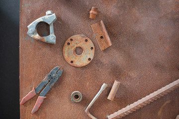 Old, dirty tools against rusty metallic surface  Background series.