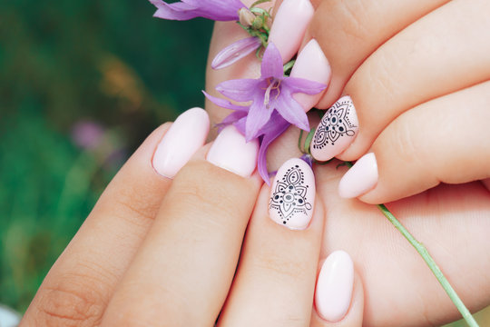 beautiful manicure close-up with a purple flower