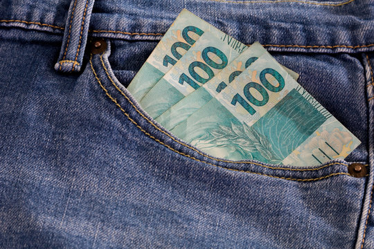 Real hundred brazilian money notes in pocket jeans. 100. Brazil finance.