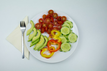 Healthy breakfast with tomato, avocado, paprika and cucumber
