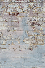 Pink and Blue paint fades away on brick wall