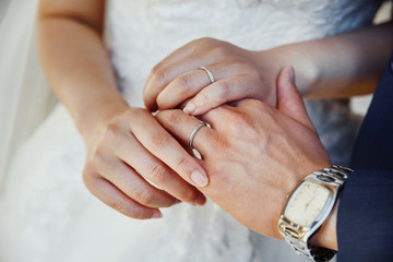 young wedding couple holding hands, groom and bride