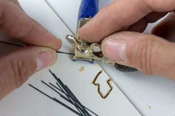 Precise saw for modelers and carpenters on the workshop table. Saw with a small blade for cutting...