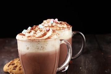 Hot chocolate cocoa with whipped cream on table.