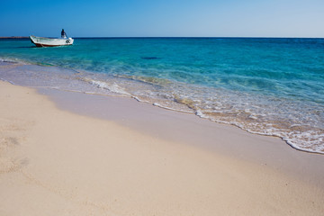 Beautiful seaside horizont with sand and blue water waves