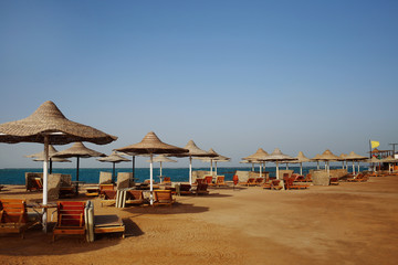 Rusty textured beach umbrellas on the empty beach in the morning
