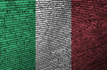 Italy flag  is depicted on the screen with the program code. The concept of modern technology and...