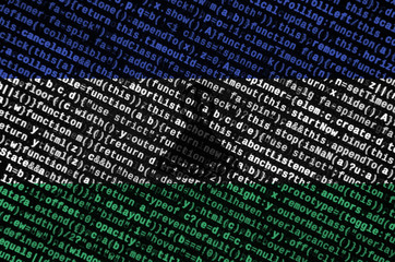 Lesotho flag  is depicted on the screen with the program code. The concept of modern technology and...