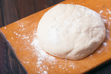 Dough on wooden background