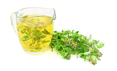 Fresh Wild Thyme Tea in a Glass with a Bunch of Thyme Herb. Also Tymus Vulgaris, Common, German or...