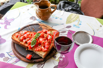 bruschetta in a heart form with home made wine on a restaurant table