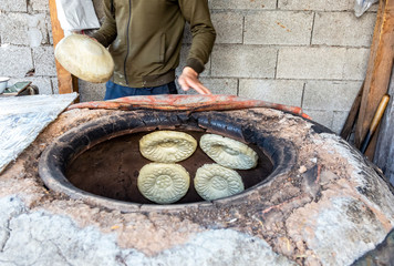 Traditional Uzbek flatbread baking in the tandyr