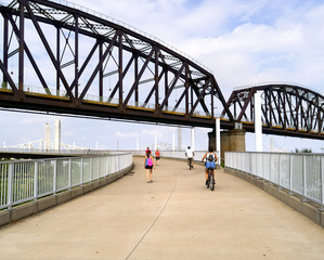 People walk and bike in Louisville Kentucky with US infrastructure, bridge and ramps