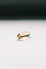 Fish oil capsule on gray background