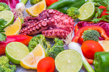 fresh octopus with colored vegetables as ingredients