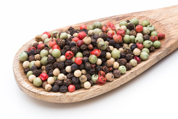 Pepper mix seed on spoon on white background.