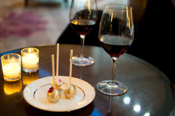 Red wine glasses and elegant dessert gold decoration cozy festive moments