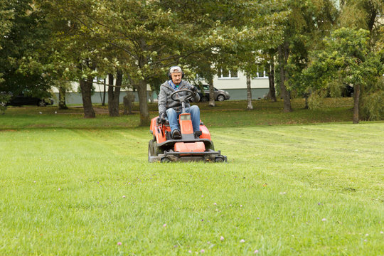 lawn mower tractor working in the town park
