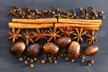 Christmas spices on wooden background.