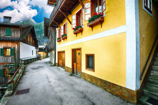 Scenic view of famous Hallstatt viilage. Typical Austrian Alpine houses with bright flowers