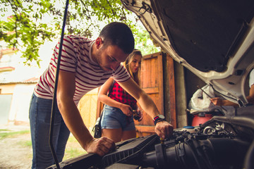 Guy fixing his car