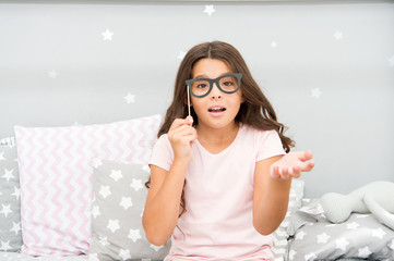 Slumber party photo booth props. Kid girl wondering posing with vintage eyeglasses party attribute. Prepare photo booth props hand made or buy for party. Printable photo booth props pajama party