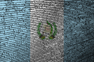 Guatemala flag  is depicted on the screen with the program code. The concept of modern technology...