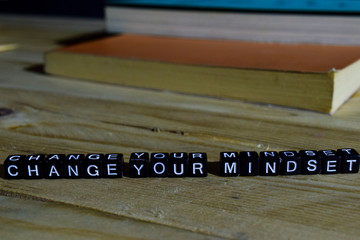 Change your mindset on wooden blocks. Motivation and inspiration concept. Cross processed image