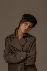 Art portrait of a beautiful girl in stylish clothes in the studio