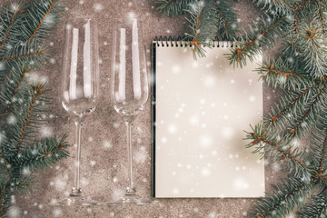 Two wineglasses and scratchpad  for wishes with Christmas tree