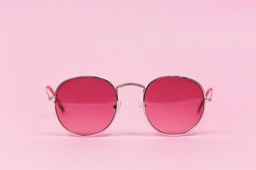 Pink sunglasses on pink background. Isolated on pink. Fashion and style