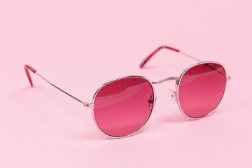 Pink sunglasses on pink background. Isolated on pink. Fashion and style