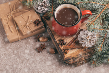 Red cup of hot cocoa on wooden cutting board