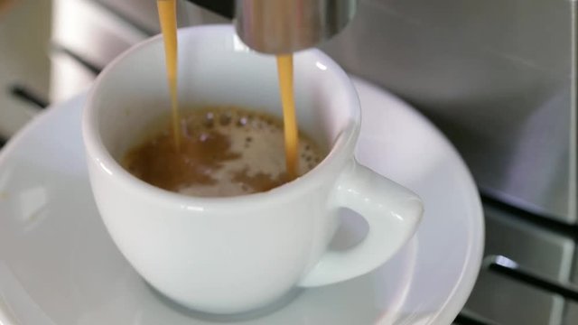 Pouring espresso coffee machine closeup