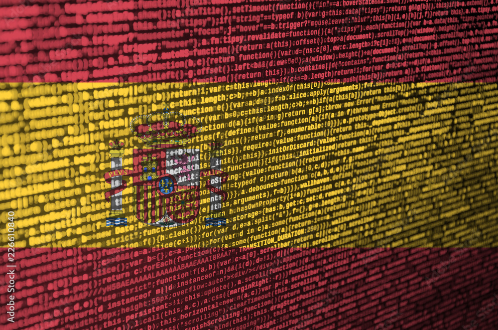 Poster spain flag is depicted on the screen with the program code. the concept of modern technology and sit