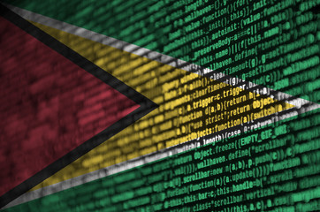 Guyana flag  is depicted on the screen with the program code. The concept of modern technology and...