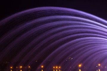 Coloured fountain water jets at night