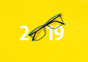 happy new year 2019.  2019 with glasses on yellow isolated background